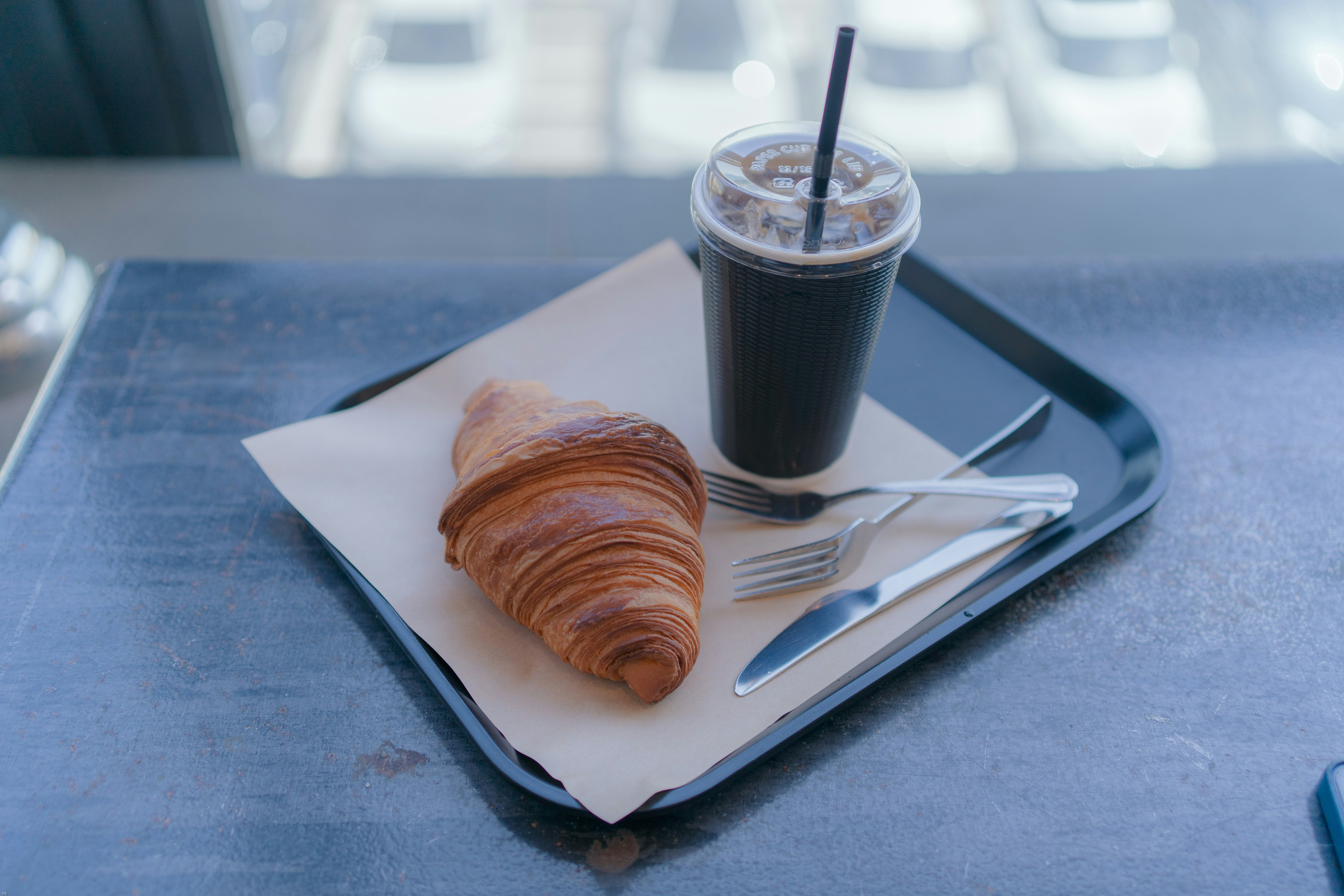 bread on white ceramic plate beside clear drinking glass